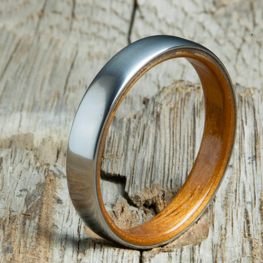 Hawaiian Koa wood lined womens wood ring with satin titanium. Custom handcrafted womens wooden rings are made by Peacefield Titanium