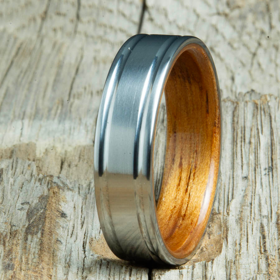 Double groove satin titanium wood ring with Hawaiian Koa interior. Unique handcrafted wedding rings made by Peacefield Titanium