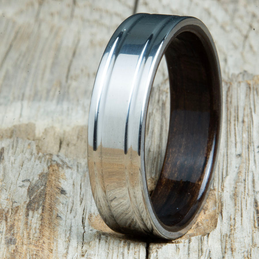 Machined titanium wedding band with Ebony interior liner. Unique custom made titanium wedding bands made by Peacefield Titanium