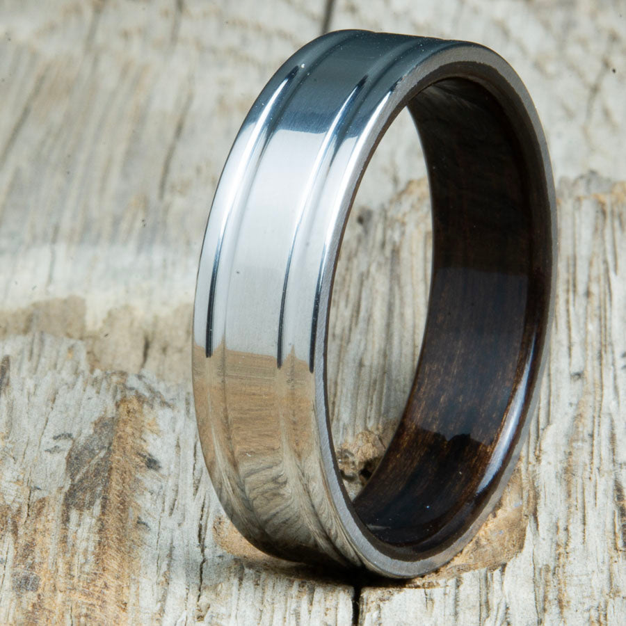 Machined titanium wedding band with Ebony interior liner. Unique custom made titanium wedding bands made by Peacefield Titanium