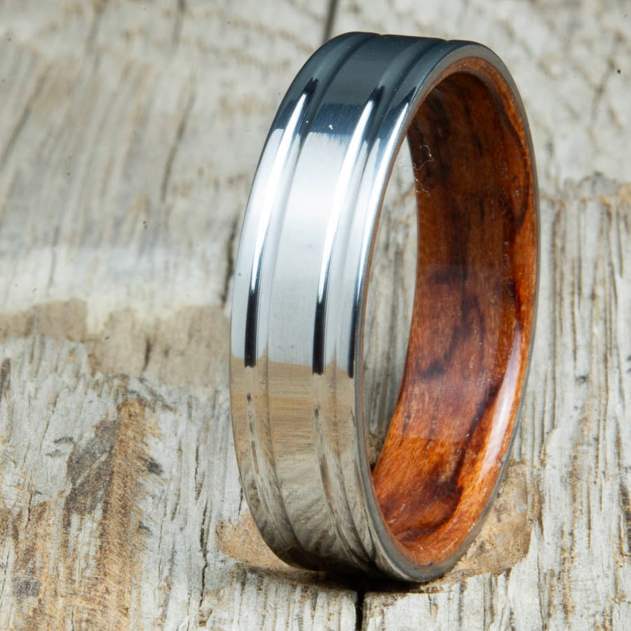 Machined titanium wedding band with Bubinga interior liner. Unique custom made titanium wedding bands made by Peacefield Titanium