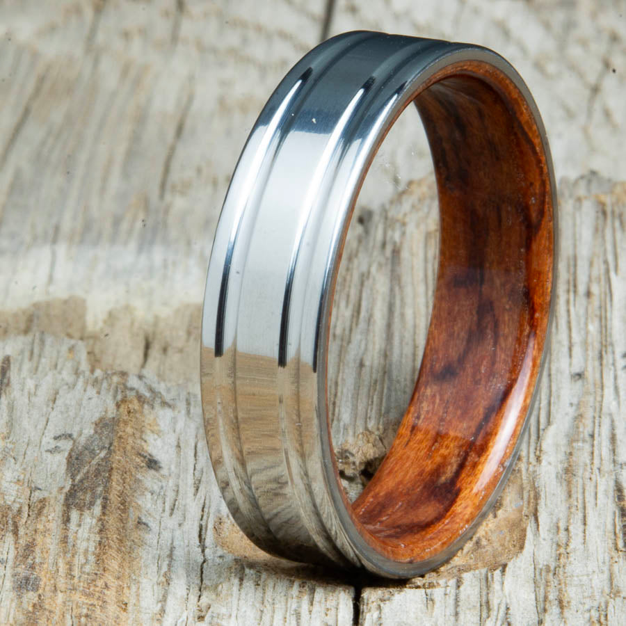 Machined titanium wedding band with Bubinga interior liner. Unique custom made titanium wedding bands made by Peacefield Titanium