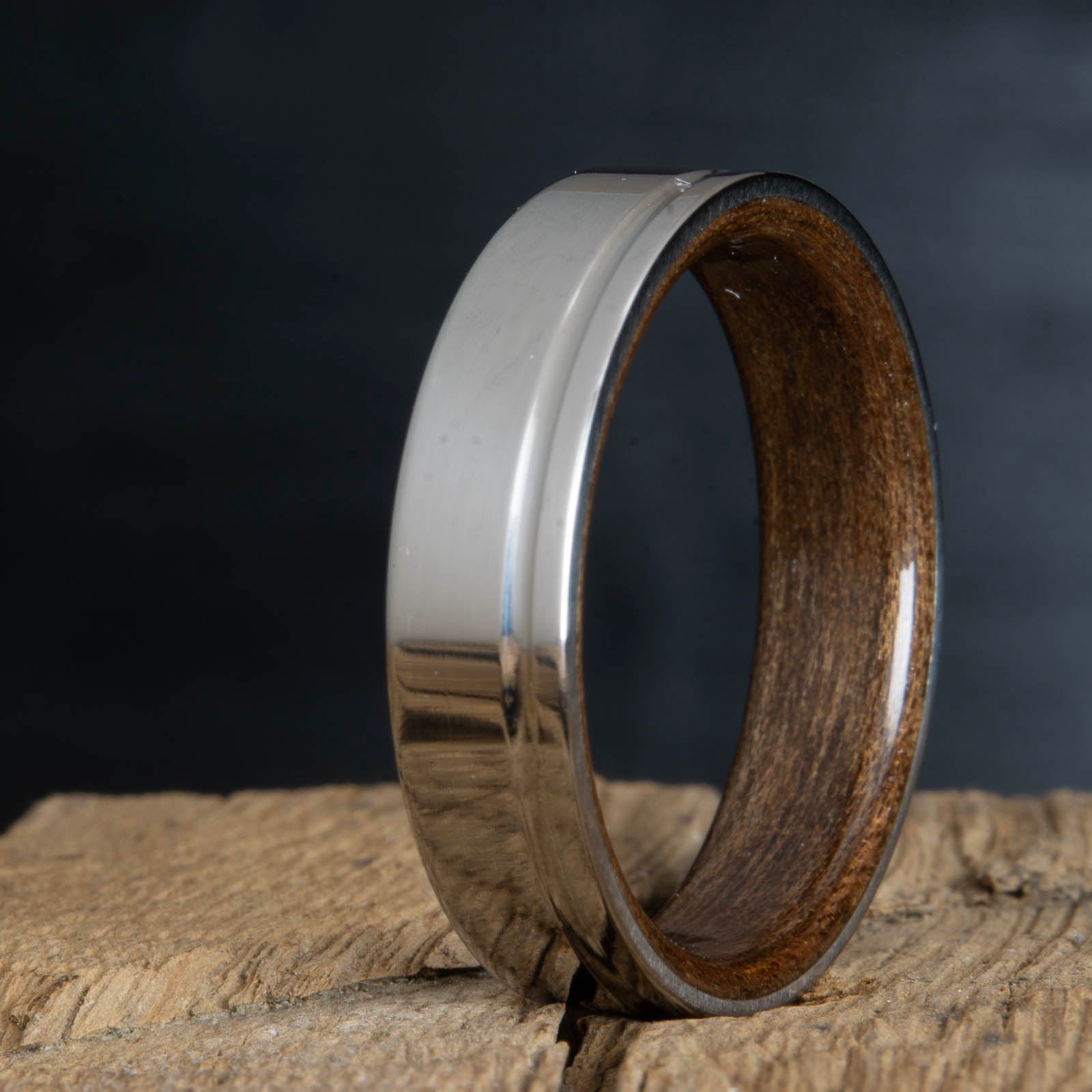 single polished offset groove on titanium ring with walnut interior