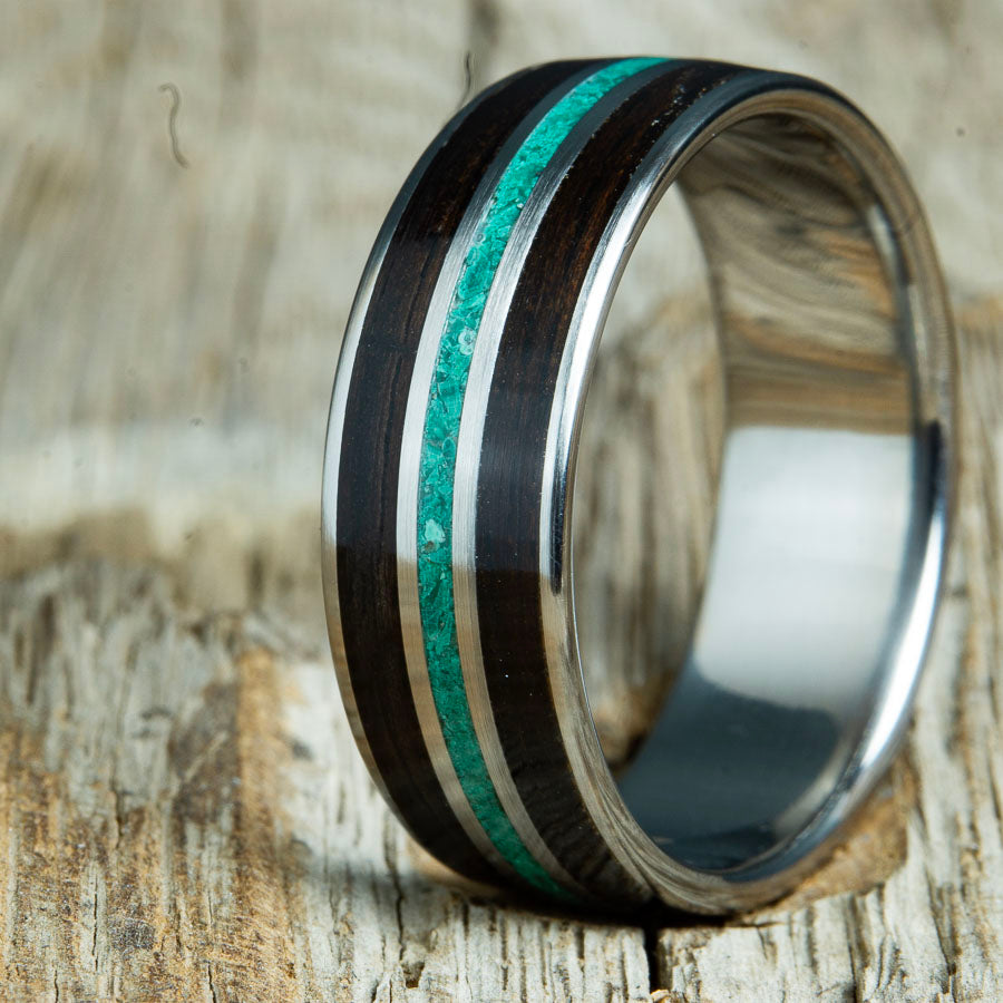 Wood ring for men with Ebony wood and Malachite stone on polished titanium custom made by Peacefield Titanium. Unique wood rings for men with custom inlay materials