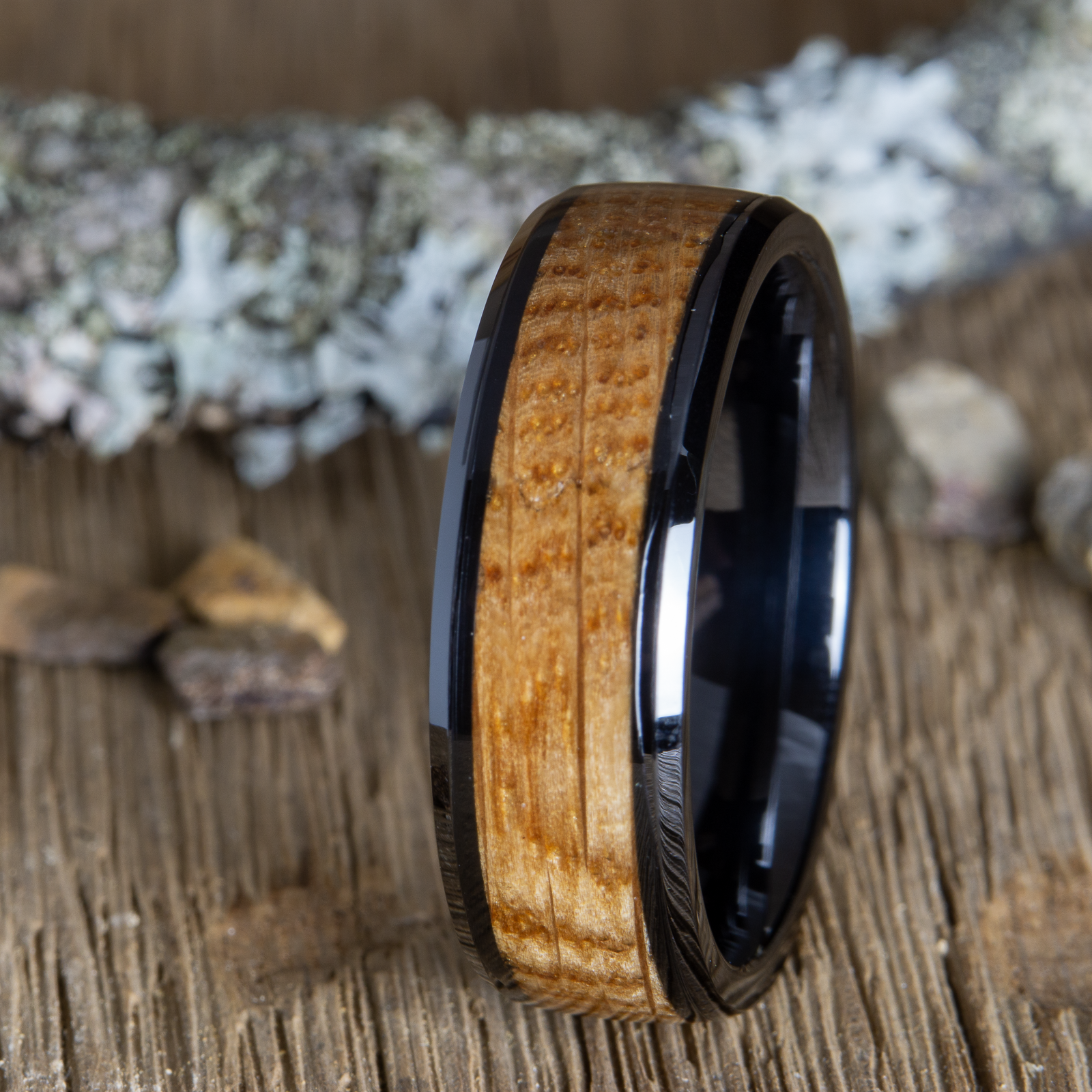 black wedding ring with whiskey barrel wood