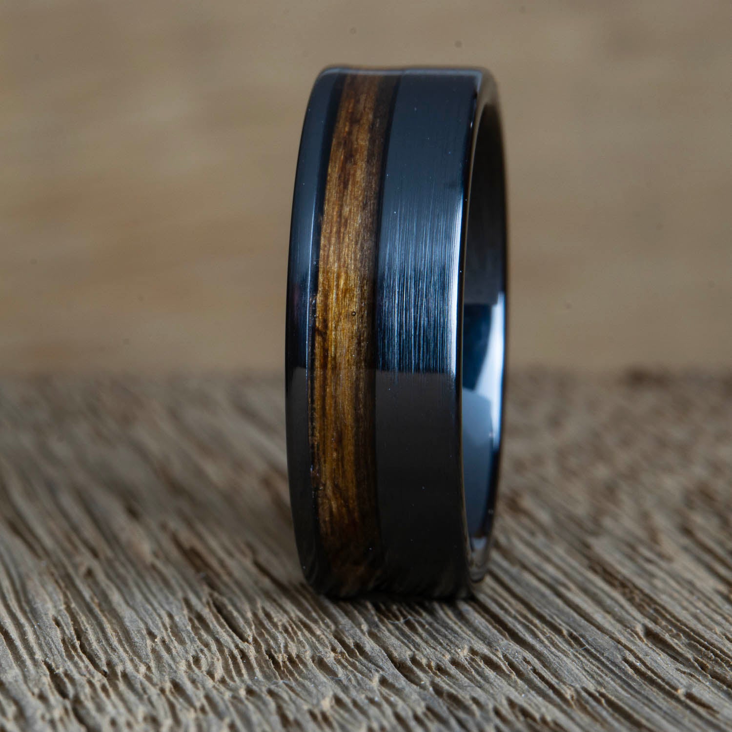 Black wedding band with offset Whiskey barrel wood inlay
