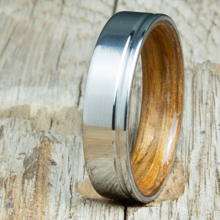 classic grooved titanium ring with whiskey barrel wood interior. Custom whiskey barrel wedding bands made by Peacefield Titanium