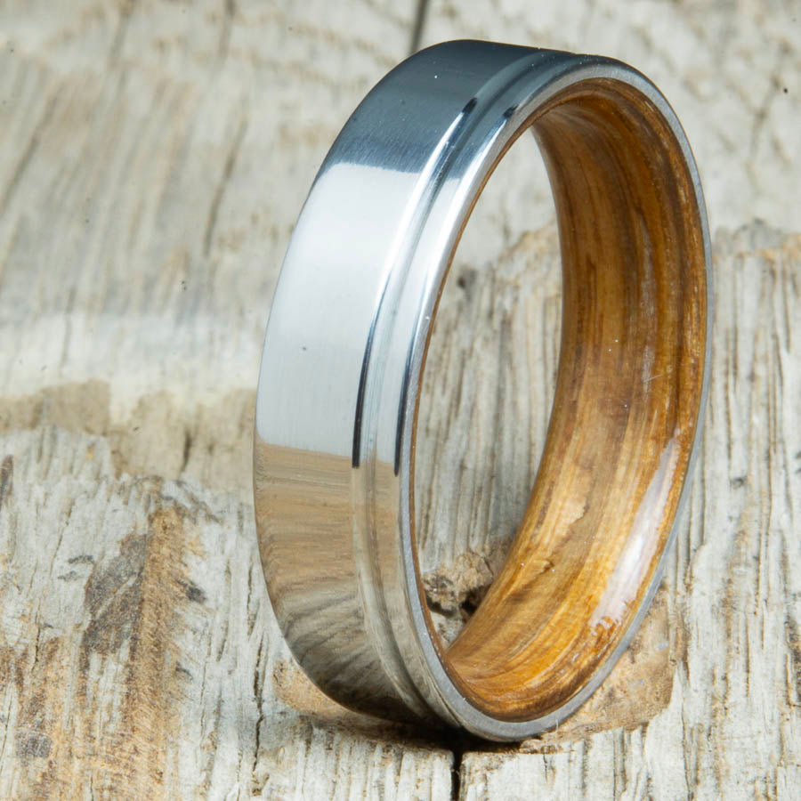 classic grooved titanium ring with whiskey barrel wood interior. Custom whiskey barrel wedding bands made by Peacefield Titanium