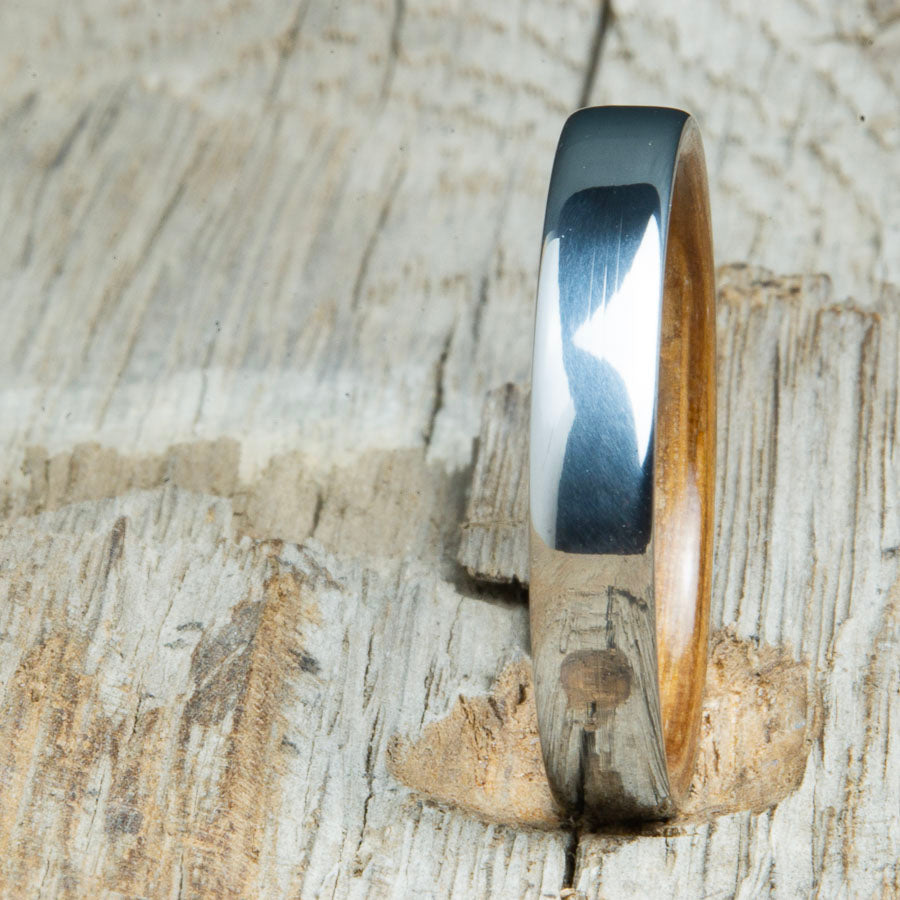 Classic domed womens wood wedding band with Whiskey barrel wood. Unique wooden rings for women made by Peacefield Titanium.