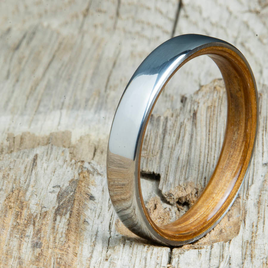 Classic domed womens wood wedding band with Whiskey barrel wood. Unique wooden rings for women made by Peacefield Titanium.