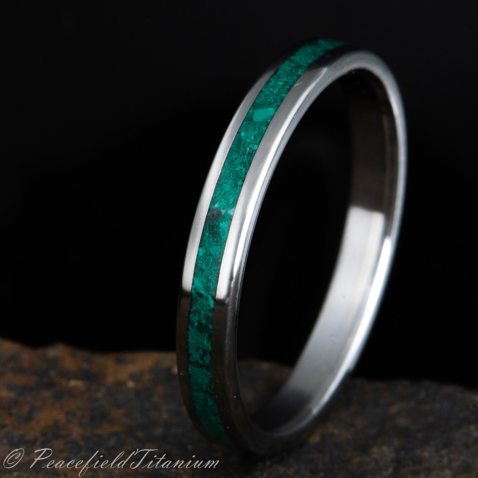 Darkgreen malachite stone inlay on polished titanium ring
