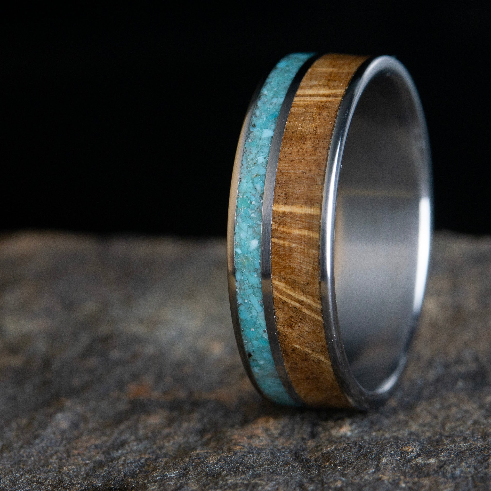 Oak burl wood with a turquoise inlay on titanium
