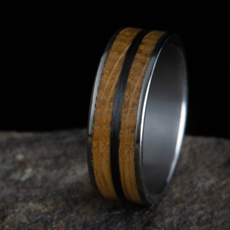 Whiskey barrel wood ring with carbon fiber inlay