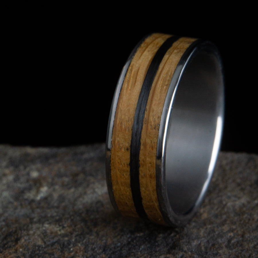 Whiskey barrel wood ring with carbon fiber inlay