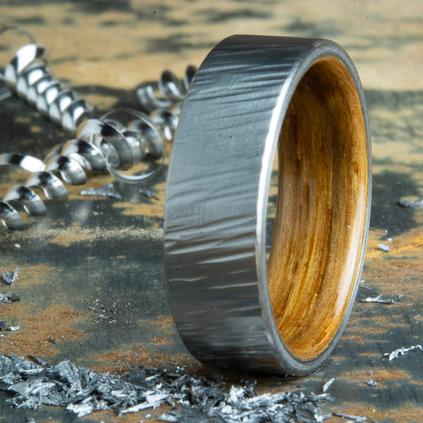 Whiskey wood lined hammered titanium ring